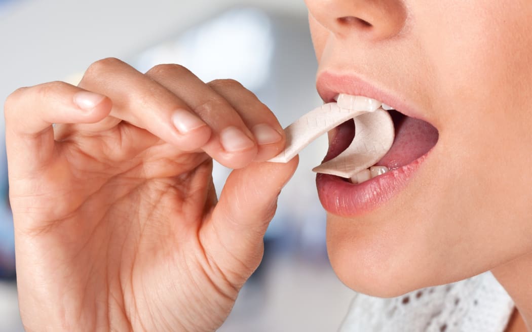 Close up of woman eating chewing gum