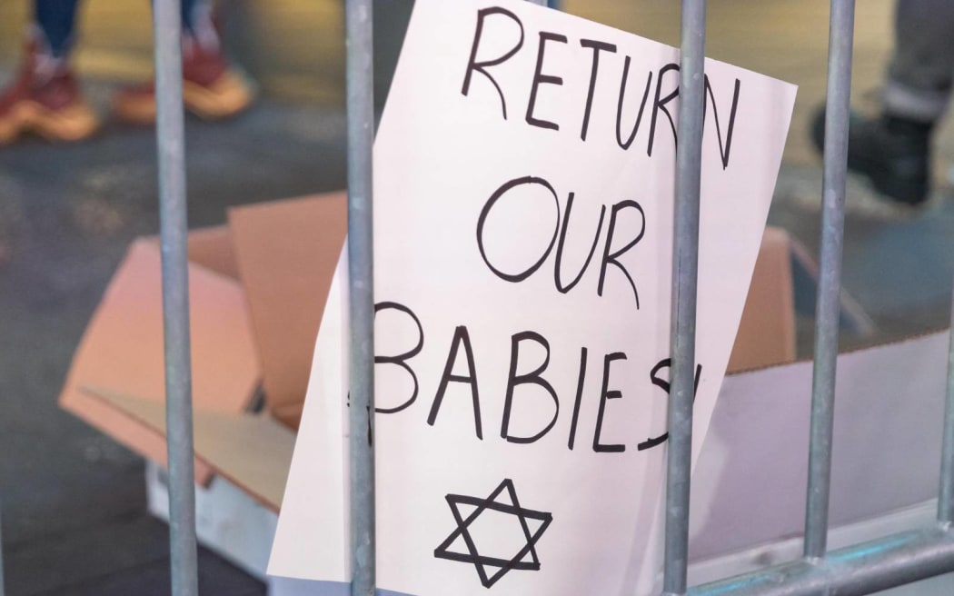 People gather for a rally in Times Square demanding Hamas free Israeli hostages on October 19, 2023 in New York City. Family members of hostages held by Hamas were joined by politicians, members of the Israeli community and supporters as they demanded the release of the men, women, and children that were kidnapped by the militant group during its attack on October 7. The event, which was organized by the Israeli-American Council (IAC) and other Jewish community organizations, also projected the faces of the hostages on 15 billboards and showed holograms of the hostages' families on the rally stage. Israeli officials have reported that Hamas has 199 hostages (Photo by VANESSA CARVALHO / BRAZIL PHOTO PRESS / Brazil Photo Press via AFP)