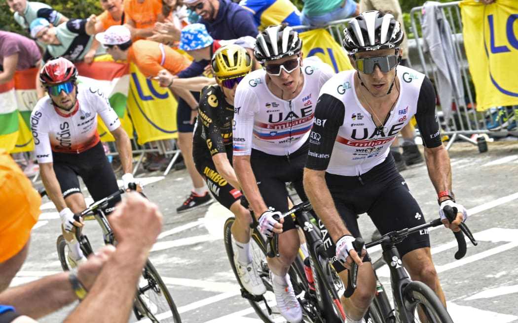 UAE Team Emirates' British rider Adam Yates (R) cycles in the ascent of the col de Pike ahead of UAE Team Emirates' Slovenian rider Tadej Pogacar (2nd R), Jumbo-Visma's Danish rider Jonas Vingegaard (C) and Cofidis' French rider Victor Lafay (L) during the 1st stage of the 110th edition of the Tour de France cycling race, 182 km departing and finishing in Bilbao, in northern Spain, on July 1, 2023. (Photo by Bernard PAPON / POOL / AFP)