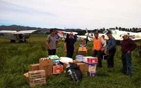 Members of the farming community come together to get supplies out to isolated farmers.