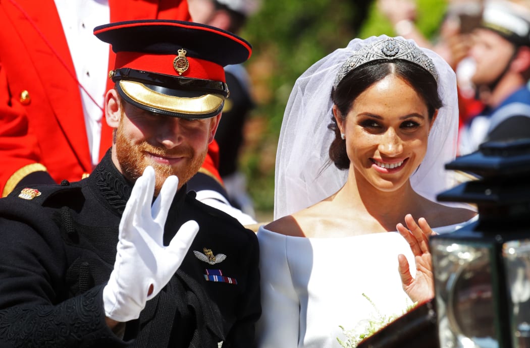 Meghan, Duchess of Sussex begins her carriage procession with Britain's Prince Harry, Duke of Sussex in the Ascot Landau Carriage after their wedding ceremony at St George's Chapel, Windsor Castle, in Windsor, on May 19, 2018.  / AFP PHOTO / POOL / CHRIS JACKSON