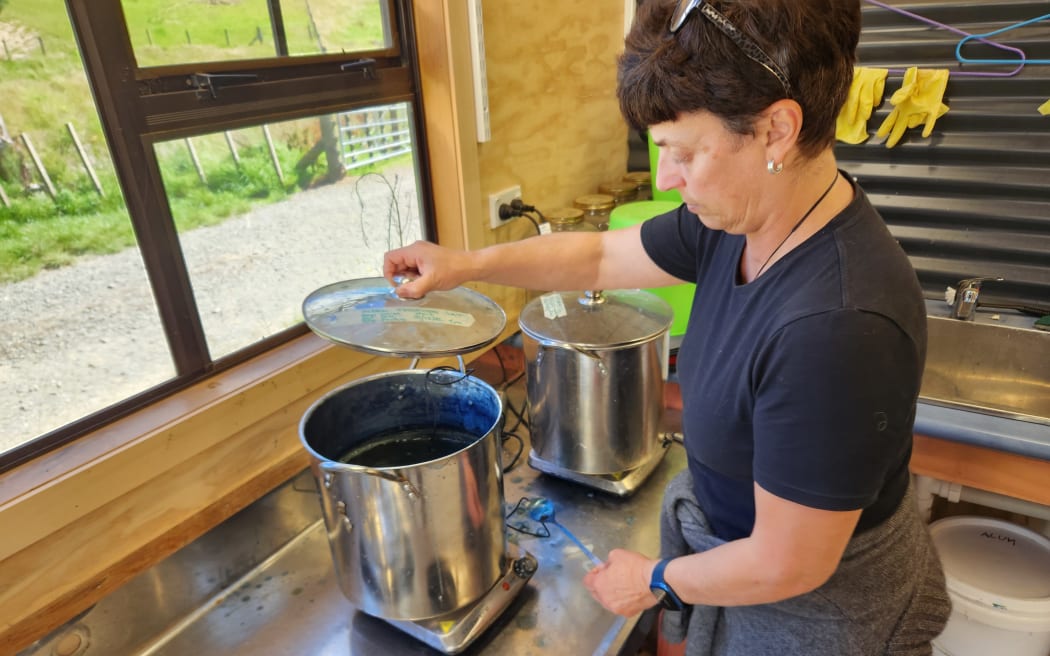 Patrizia checks on a vat of indigo dye used for colouring her home grown wool