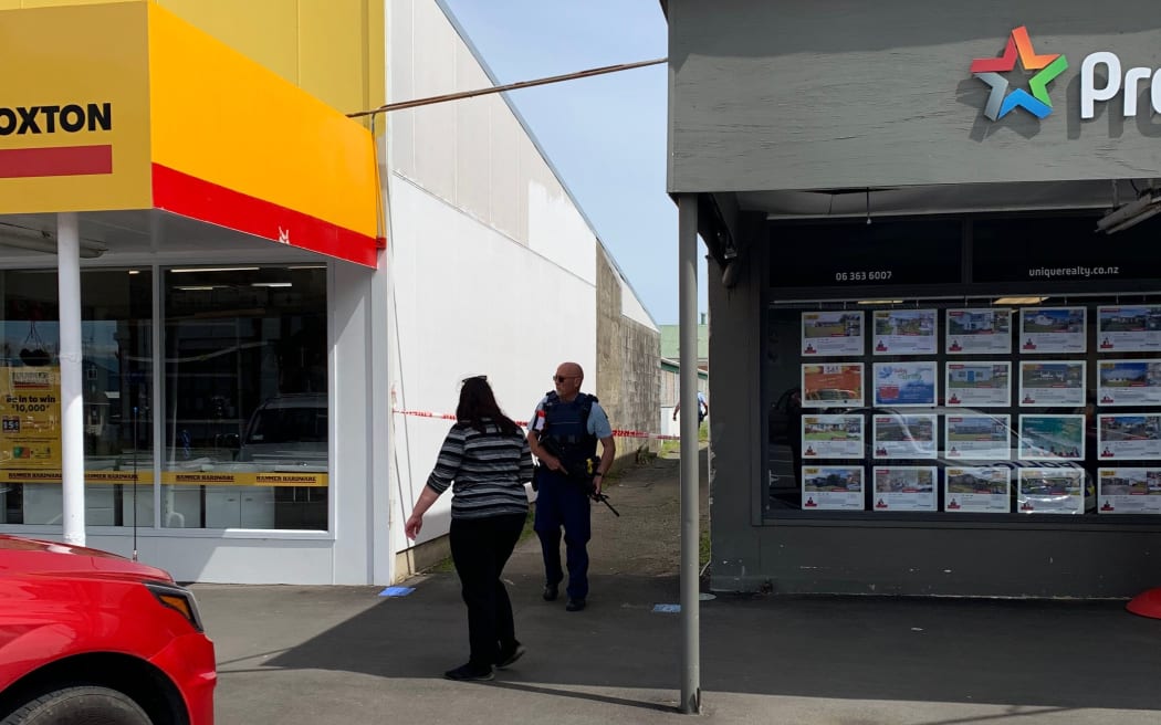 Armed officer next to Foxton Hammer Hardware in Main St, Foxton