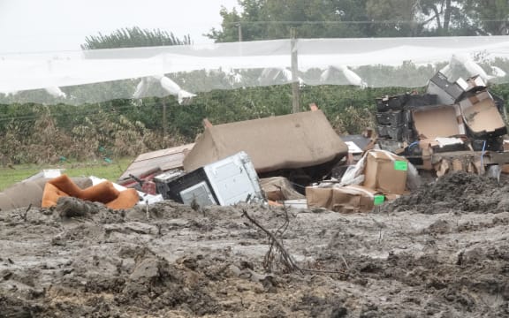 Van Beek, his family and staff are piling silt and rubbish were apple trees once stood.