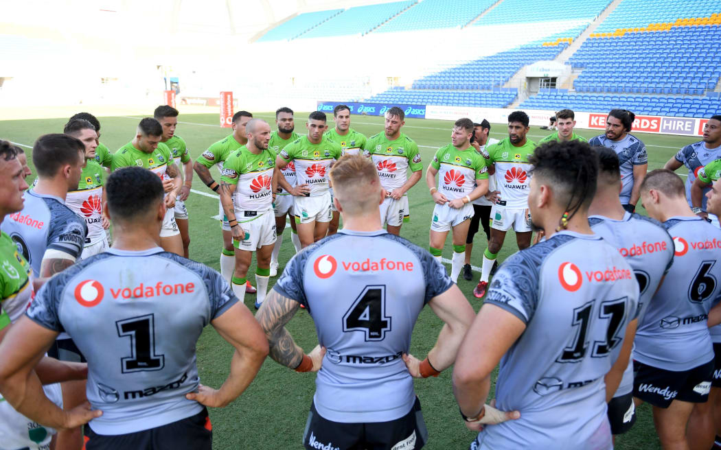 Canberra players talk to the Warriors players at the end of the match. 2020