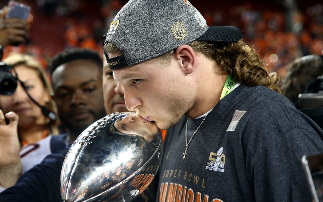 The Denver Broncos' Jordan Taylor kisses the Vince Lombardi Trophy after defeating the Carolina Panthers in Super Bowl 50, February 7, 2016 in Santa Clara. Patrick Smith/Getty Images/AFP