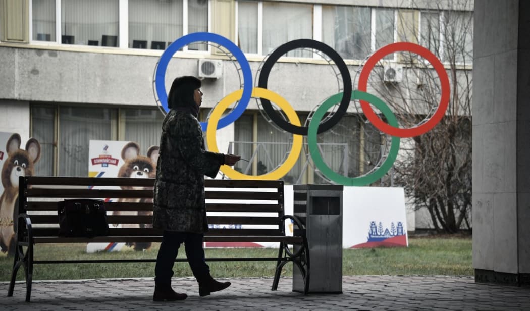 A woman smokes in front of the Russian Olympic Committee (ROC) headquarters in Moscow on November 26, 2019. - Russia's anti-doping chief said on November 26, 2019 he expected the country to be barred from all sporting competition for four years,