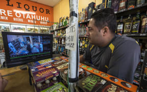 Liquor store owner Sunny Sahota looks over security footage after an incident.  Story on the daily threats storeowners have with robberies.