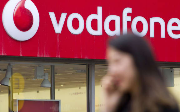 woman talking on phone outside vodafone store