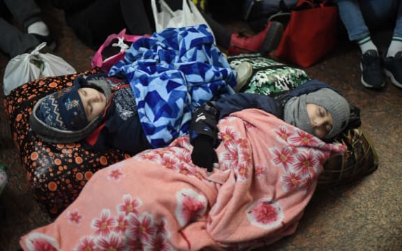 Children are sleeping on the floor at Lviv central train station in Western Ukraine on February 26, 2022.