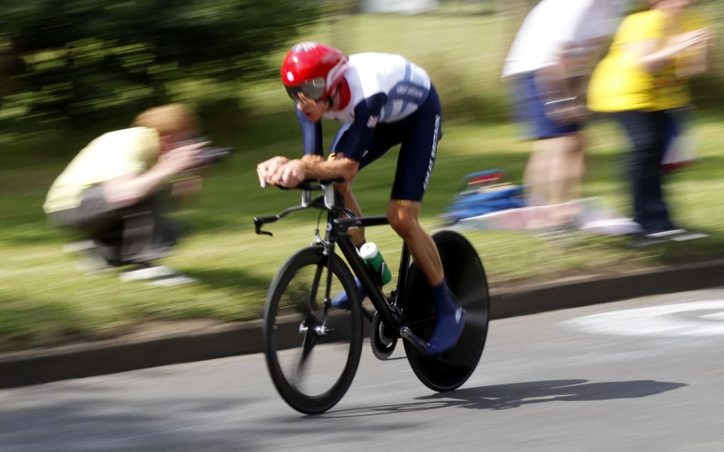 British cyclist Bradley Wiggins wins Olympic gold.