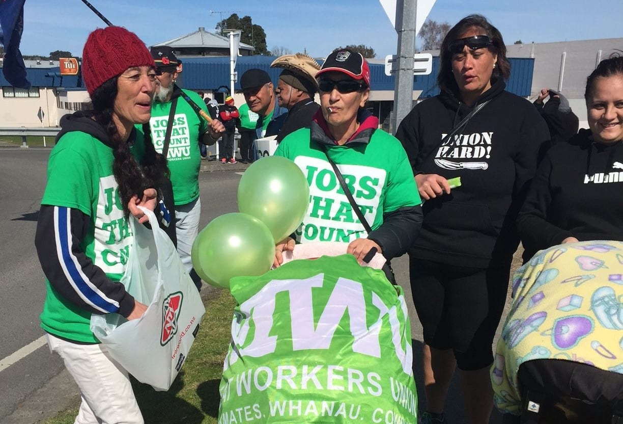 People wave balloons and banners at a protest at the Wairoa Bridge in Hawke's Bay over AFFCO employment contracts.