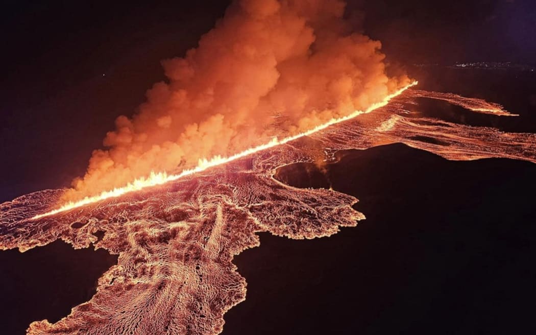 Handout picture released on August 23, 2024 by the Public Defense Department of the State Police in Iceland and taken during the night from August 22 to 23, 2024 shows lava and smoke erupting from a volcano near Grindavik on the Icelandic peninsula of Reykjanes. A new volcano erupted in southwestern Iceland on August 22, 2024, spewing hot lava into the air in the sixth eruption to hit the region since December 2023, authorities said. "An eruption has started on the Sundhnuksgigarod east of Mt. Sylingafell," the Icelandic Meteorological Office (IMO) said in a statement, adding that the eruption had started at 9:26 pm (2126 GMT) following a series of earthquakes. (Photo by Public Defense Department of the State Police / AFP) / RESTRICTED TO EDITORIAL USE - MANDATORY CREDIT "AFP PHOTO /  Public Defense Department of the State Police in Iceland" - NO MARKETING NO ADVERTISING CAMPAIGNS - DISTRIBUTED AS A SERVICE TO CLIENTS /...