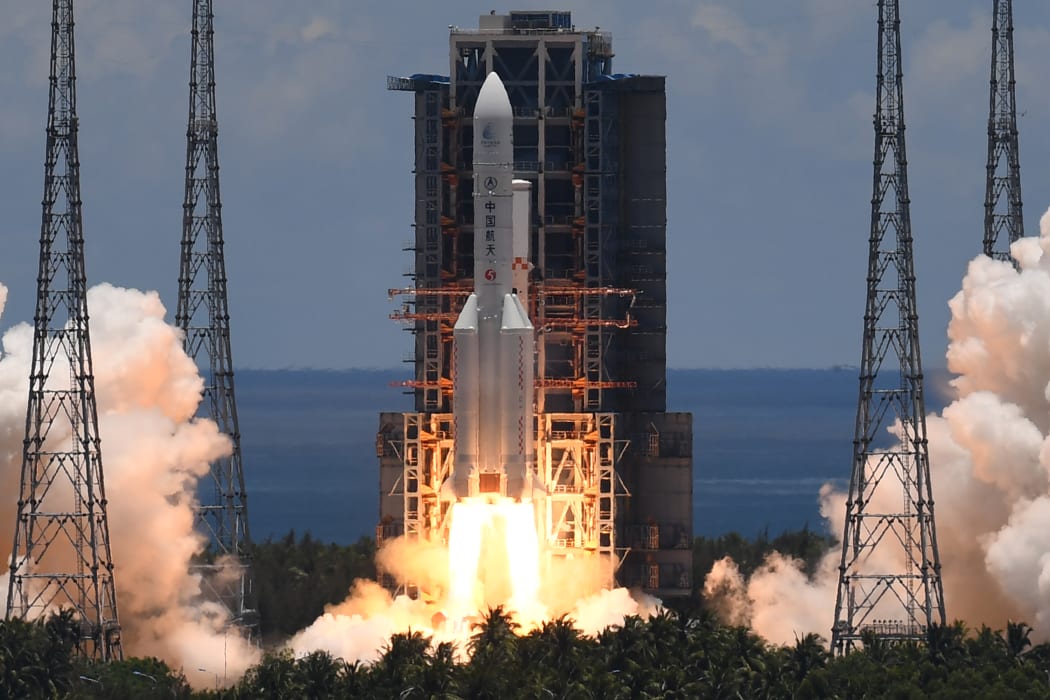 A Long March-5 rocket, carrying an orbiter, lander and rover as part of the Tianwen-1 mission to Mars, lifts off from the Wenchang Space Launch Centre in southern China's Hainan Province on 23 July 2020.
