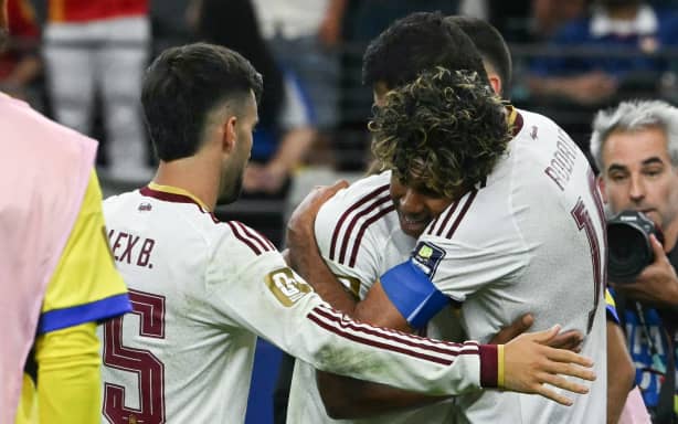 Spain's forward #19 Lamine Yamal (C) and Spain's midfielder #16 Rodri (R) embrace as they celebrate their team's victory at the end of the 2026 World Cup football tournament semi-final match between France and Spain at the Dallas Stadium in Arlington on July 14, 2026. (Photo by RONALDO SCHEMIDT / AFP)