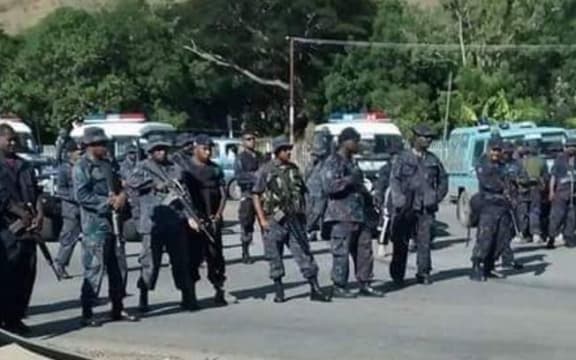 Police stand at the students protests.