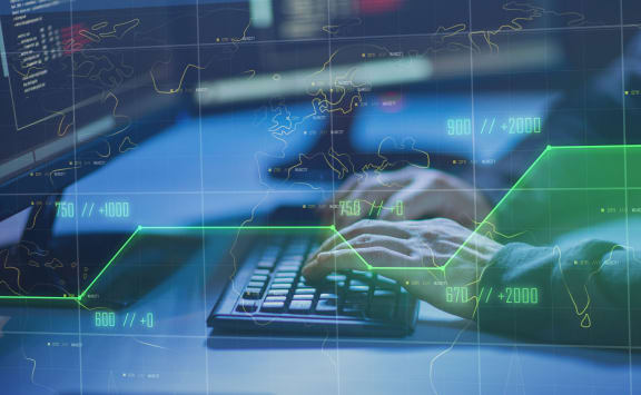cybercrime, hacking and technology concept - hands of hacker in dark room writing code or using computer virus program for cyber attack