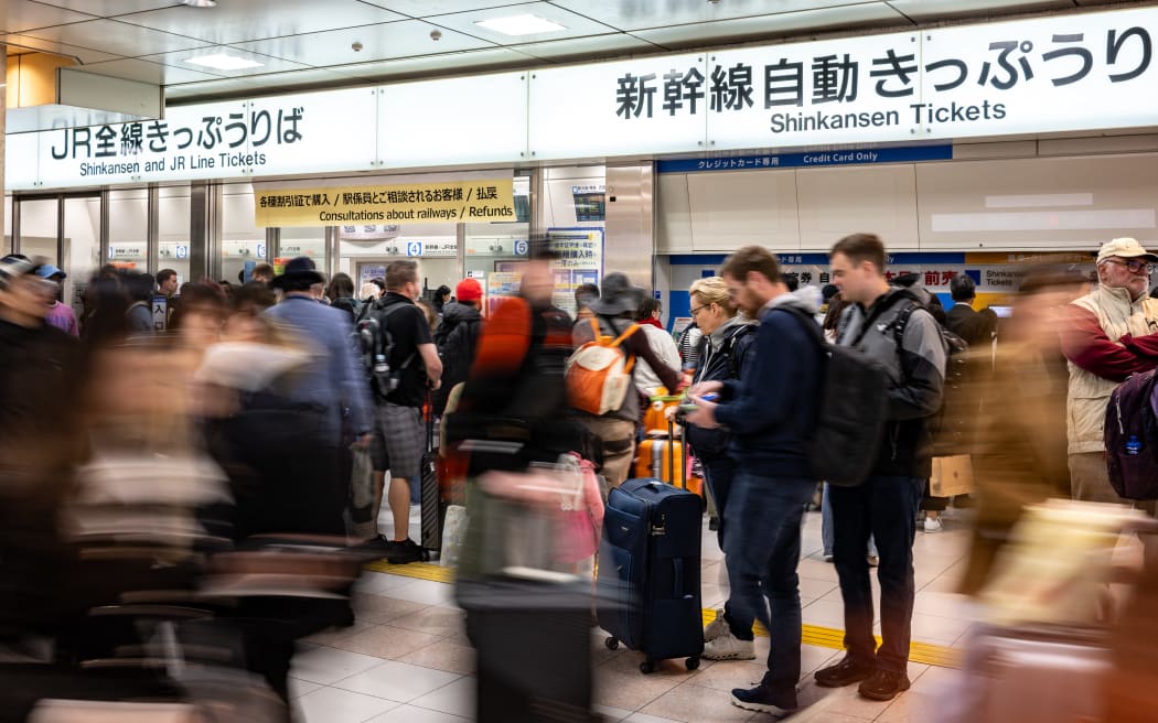 Foreign tourists gather at Kyoto station on April 16, 2025. (Photo by Philip FONG / AFP)
