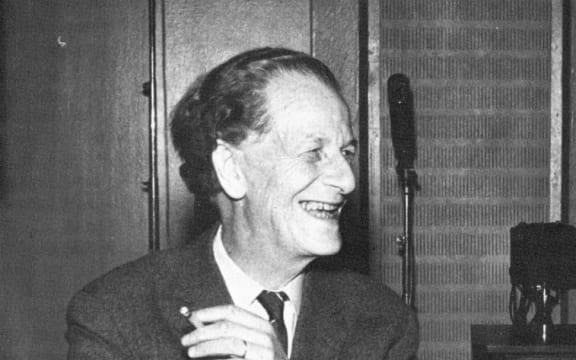composer Frank Martin laughing with cigarette in hand