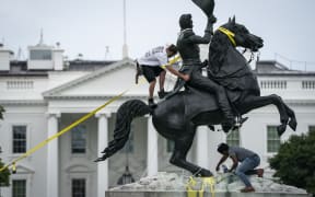 Protesters attempt to pull down the statue of Andrew Jackson in Lafayette Square near the White House on June 22, 2020 in Washington, DC, US