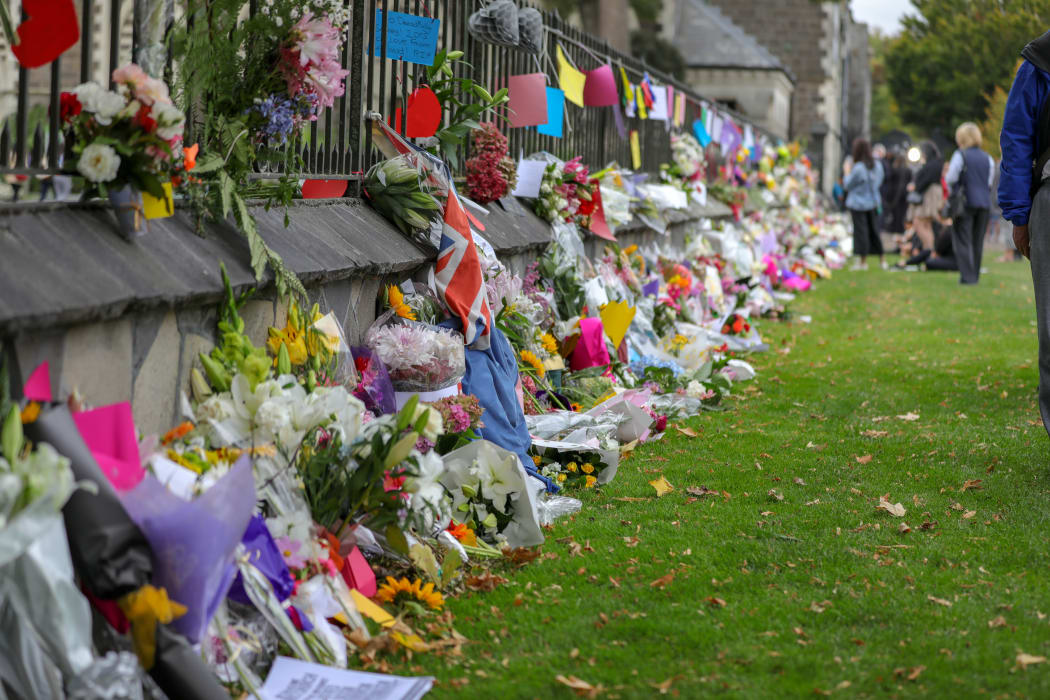 Christchurch Botanic Gardens wall with hundreds of flowers laid in memory of those lost in the mosques shooting