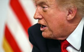 US President Donald Trump participates in a video call with military service members from his Mar-a-Lago residence in Palm Beach, Florida, on November 27, 2025, during the Thanksgiving holiday. US President Donald Trump said Thursday that Sarah Beckstrom, one of the two National Guard troops shot a day earlier near the White House, had died, while the other soldier was "fighting for his life." (Photo by Jim WATSON / AFP)