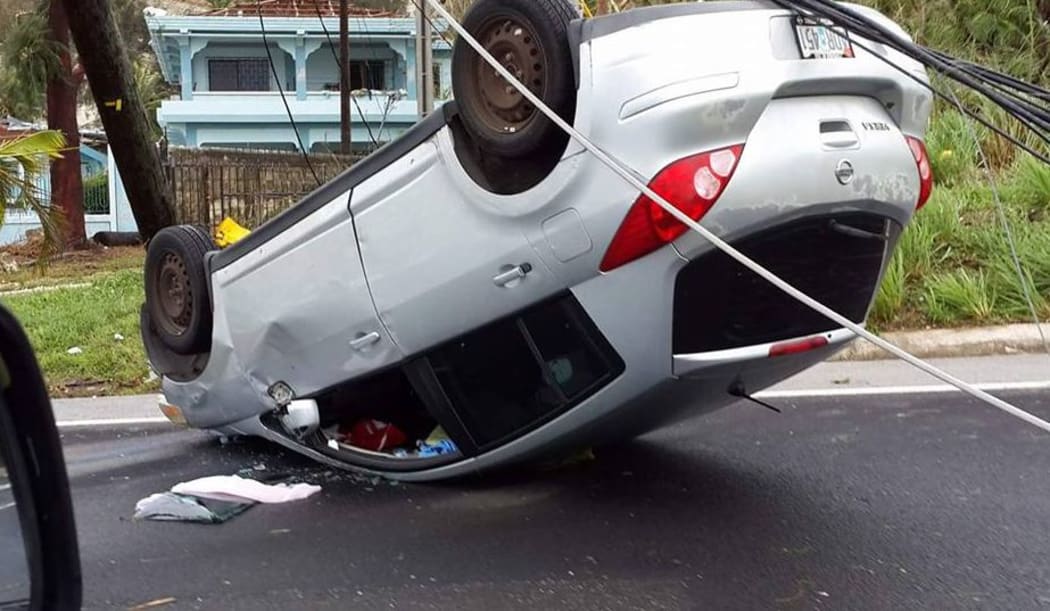 Car in Saipan left upside down by Typhoon Soudelor