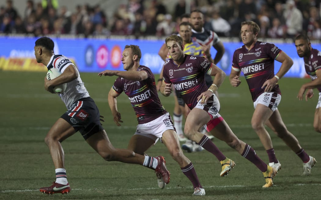 Manly Sea Eagles players wearing a rainbow-trimmed Pride jerseys during the rugby league match between the Manly Sea Eagles and Sydney Roosters in Sydney on 28 July 2022.