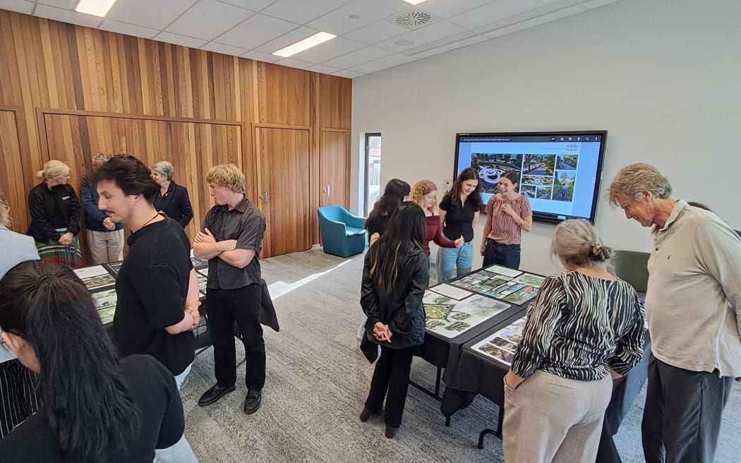 Victoria University architecture students mingle with the community at the opening of the Reimagining Nelson Square exhibition.