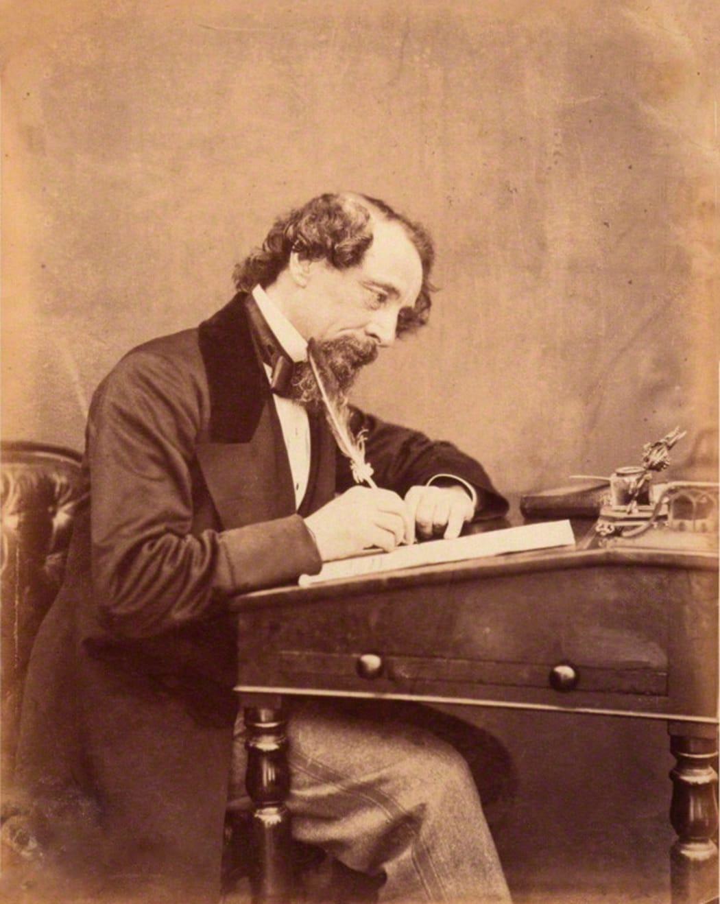Charles Dickens at his Desk in 1858