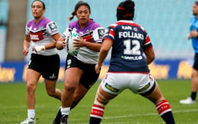 Onjeurlina Leiataua taking on the Rooster's  defence