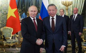 In this pool photograph distributed by Russian state agency Sputnik, Russia's President Vladimir Putin (L) shakes hands with the General Secretary of the Communist Party of Vietnam Tô Lâm in Moscow on May 10, 2025, during celebrations of the 80th anniversary of the Soviet Union's victory over Nazi Germany in World War Two. (Photo by Gavriil GRIGOROV / POOL / AFP) / ***EDITOR'S NOTE : THIS IMAGE IS DISTRIBUTED BY THE RUSSIAN STATE OWNED AGENCY SPUTNIK***
