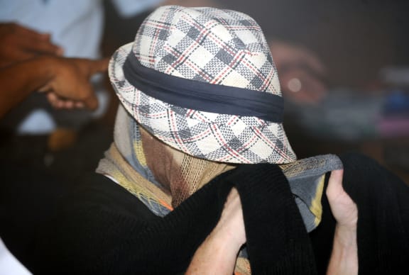 Schapelle Corby with her face covered on Monday.