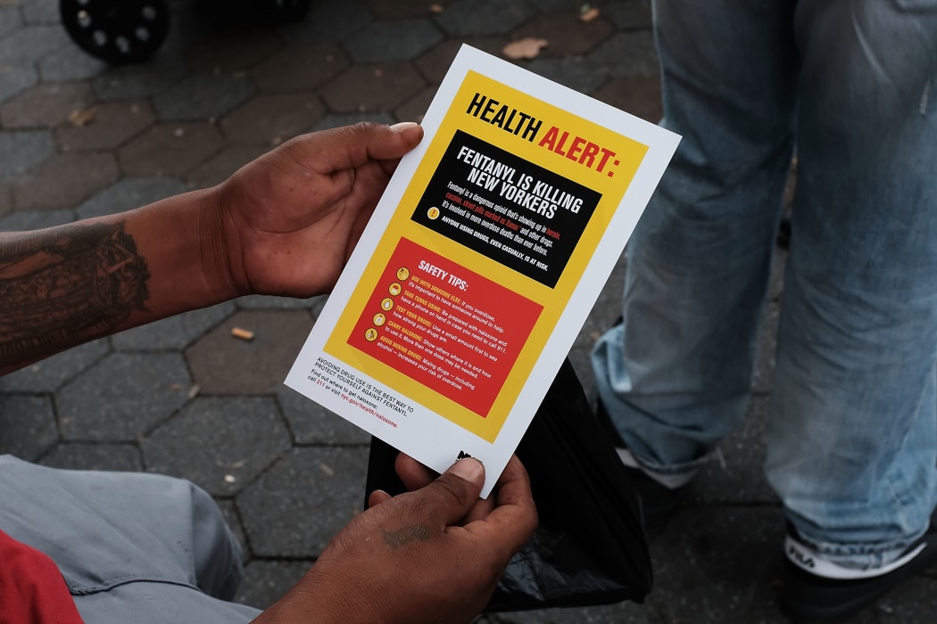 A person in New York City reads an alert on fentanyl before being interviewed by John Jay College of Criminal Justice students as part of a project on August 8, 2017.