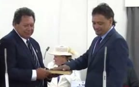 In this screenshot from the Parliament live  stream, Albert Nicholas (right) is sworn in as a member of the Cook Islands Parliament on 9 April 2019.