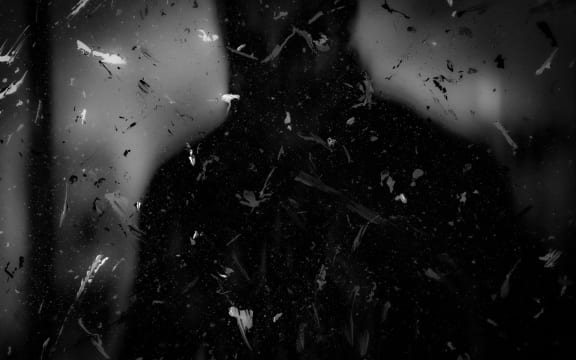 Dark silhouette with paint splatters