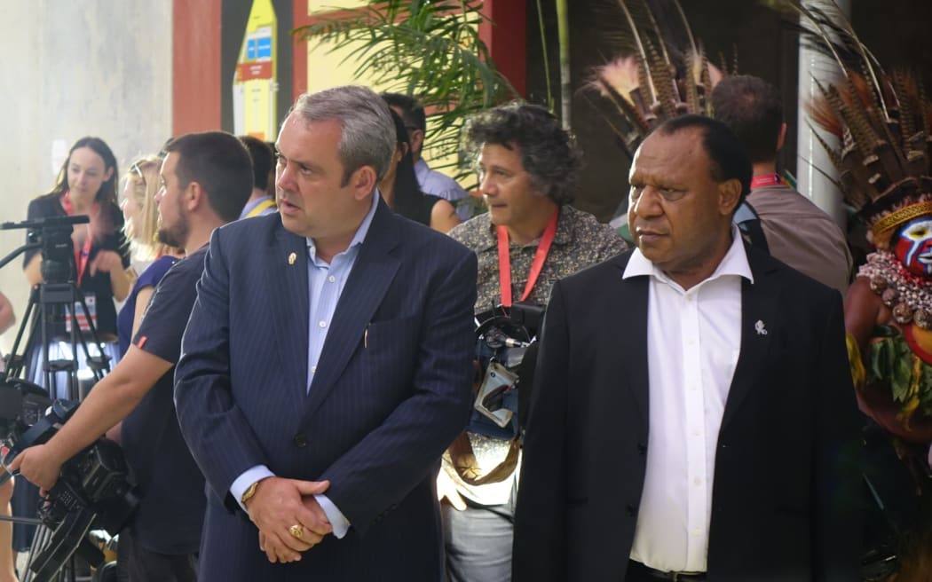 PNG's Sports Minister Justin Tkatchenko waits with the Foreign Minister Rimbink Pato