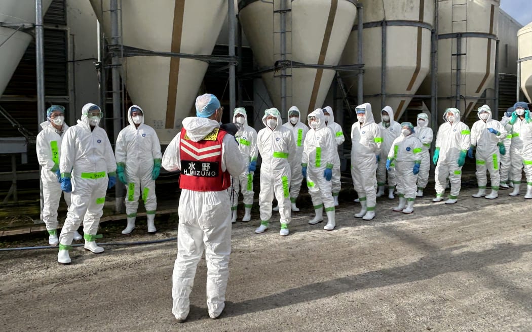 A team carrying out disinfecting in Japan's Ibaraki prefecture to guard against bird flu, after confirmation of a bird flu outbreak there, in November 2023.