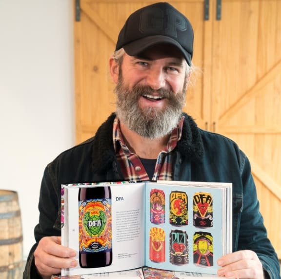 Pete Gillespie with book (Supplied)
