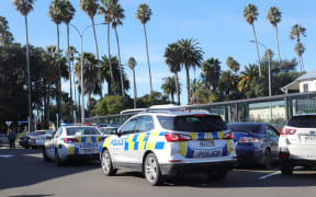 Police around the palm trees of Clive Square, just around the corner from the city’s homeless outreach centre.