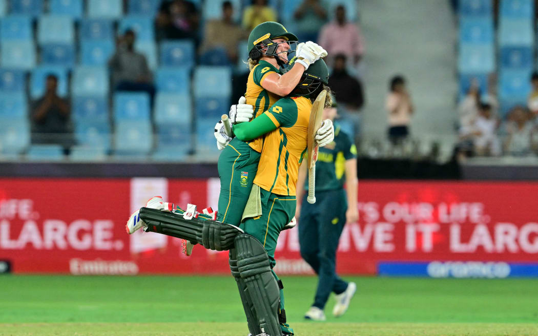 South Africa's Anneke Bosch (L) and Chloe Tryon celebrate their win at the end of the ICC Women's T20 World Cup cricket semi-final match against Australia, 2024.