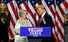 Former US President and Republican presidential candidate Donald Trump greets his campaign manager Susie Wiles (L) during an election night event at the West Palm Beach Convention Center in West Palm Beach, Florida, on November 6, 2024. - Republican former president Donald Trump closed in on a new term in the White House early November 6, 2024, just needing a handful of electoral votes to defeat Democratic Vice President Kamala Harris. (Photo by Jim WATSON / AFP)