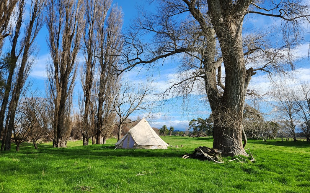 The bell tent is situated by the river