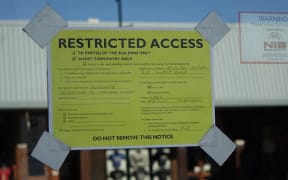 A yellow sticker warns of damage at Adelphi Hotel in Kaikōura.