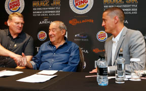 Duco co-director Dean Lonergan (L) shakes hand's with Top Rank CEO Bob Arum (C) along with Duco co-director David Higgins.