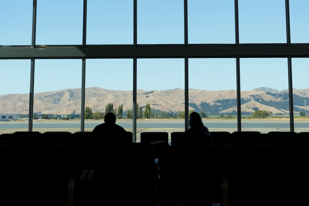 A married couple social distance at Marlborough Airport in March.