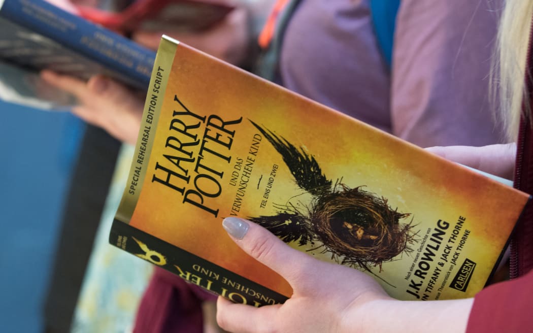 22 March 2019, Saxony, Leipzig: Books from the fantasy novel series Harry Potter will be read at Carlsen's stand at the Leipzig Book Fair. The Book Fair will continue until 24.03.2019. Photo: Hendrik Schmidt/dpa-Zentralbild/ZB (Photo by HENDRIK SCHMIDT / dpa-Zentralbild / dpa Picture-Alliance via AFP)