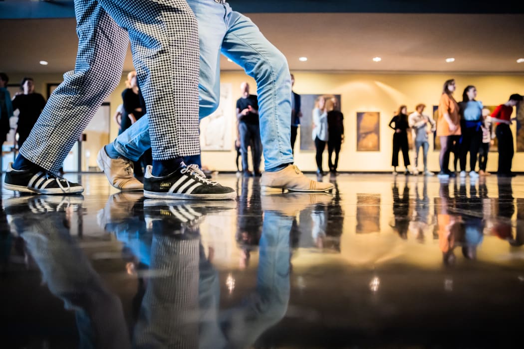 05 November 2022, Berlin: A couple dances at a free swing or Lindy Hop dance class to warm up in the foyer of the Deutsche Oper. The Berlin State Ballet and the Deutsche Oper offer free dance classes on Saturdays in November to brave the dropping temperatures with tango, swing and salsa. Photo: Christoph Soeder/dpa (Photo by Christoph Soeder / DPA / dpa Picture-Alliance via AFP)