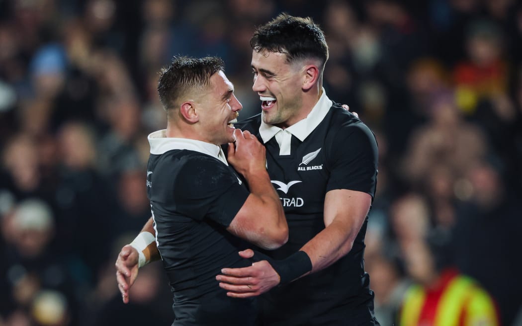 Will Jordan celebrates his try with Cortez Ratima.