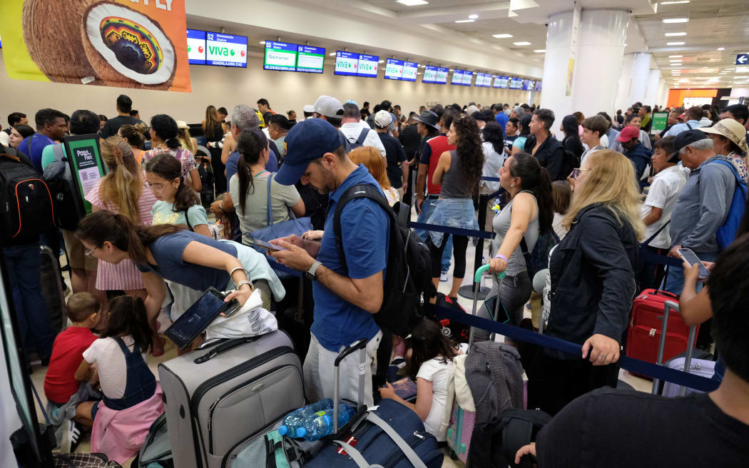 Passengers wait for their flights at the Cancun airport in Quintana Roo state, Mexico on 19 July, 2024.